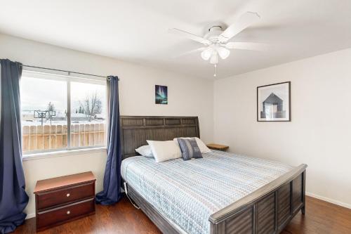 a bedroom with a bed and a ceiling fan at Friendly Cove in Anchorage