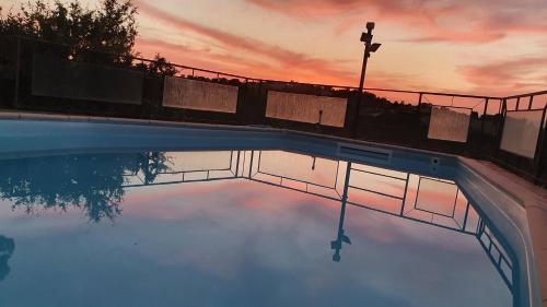 a reflection of a sunset in a swimming pool at IL PAGO in Calvi dellʼ Umbria