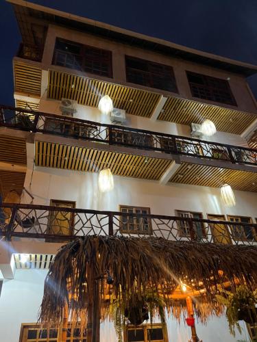 un edificio con balcón y una palmera en Habitación matrimonial con vista al mar-wanderlust, en Santa Elena