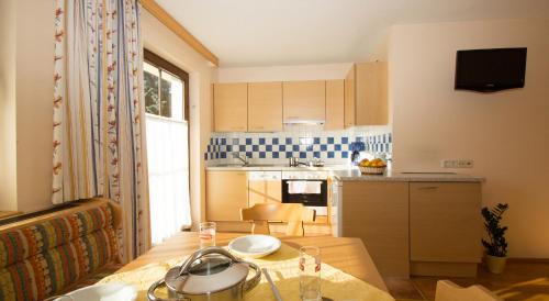 a small kitchen with a table and a dining room at Abelhof in Schladming