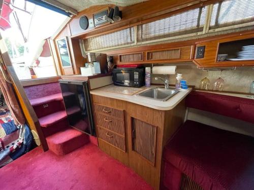 a small kitchen with a sink and a microwave at Private Yacht on Catskill Creek in Catskill