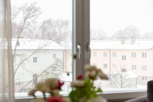 a window with a view of a snow covered city at Modern Scandinavian Home in Stockholm in Stockholm