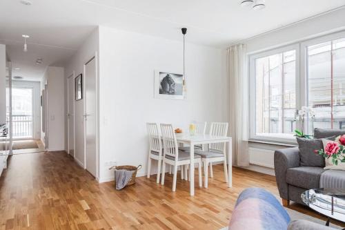 a living room with a table and a couch at Modern Scandinavian Home in Stockholm in Stockholm