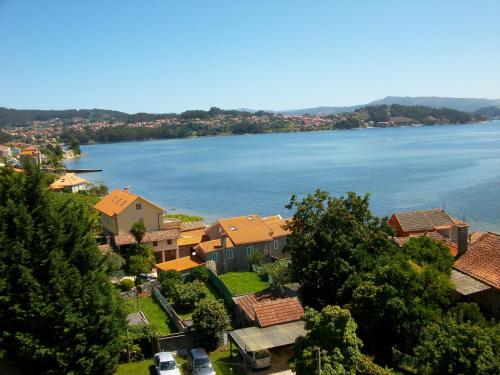 an aerial view of a town with a lake at Hotel Xeito in Combarro