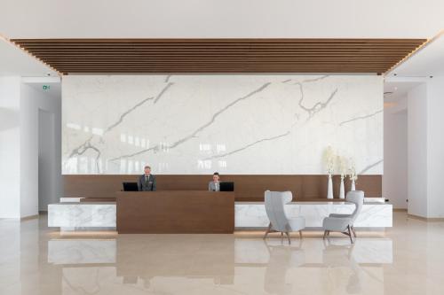 a rendering of a lobby with a marble wall at Gennadi Grand Resort in Gennadi