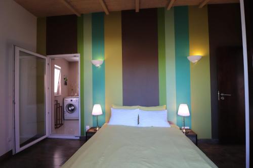 a bedroom with a large bed with striped walls at Apartamento Vista Marina in Lagos