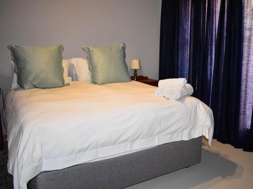 a bedroom with a bed with towels on it at Serene Guest Manor in Johannesburg