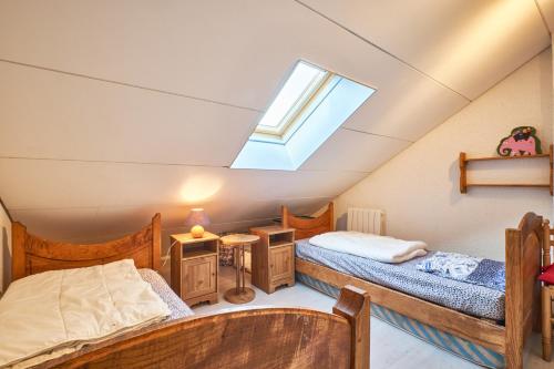 sypialnia na poddaszu z 2 łóżkami i świetlikiem w obiekcie Le koala w mieście Villard-de-Lans