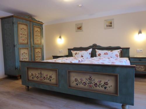 a bedroom with a large bed and a dresser at Fischerhäusle in Oberried