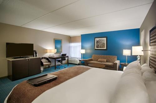 a hotel room with a large bed and a television at DoubleTree by Hilton Roseville Minneapolis in Roseville