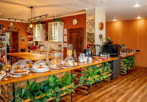 a kitchen with a long counter with food on it at Отель Ямской in Voronezh