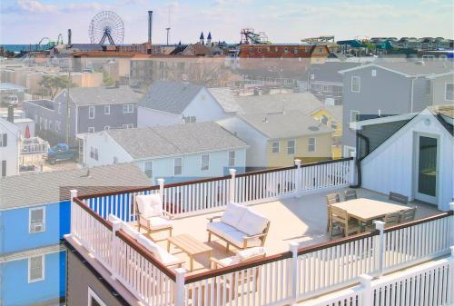 a balcony with two chairs and a table on a building at The Pelican's Perch: New Build in Seaside Heights