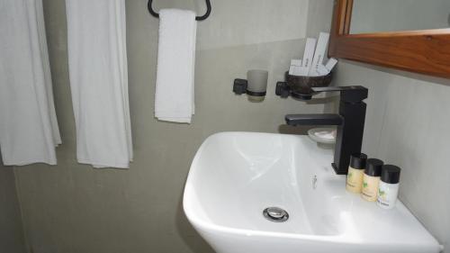 a bathroom with a white sink and a mirror at Surf View Resort in Ahangama