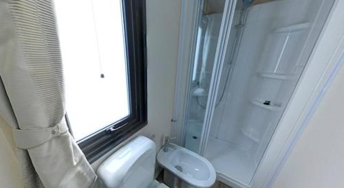 a bathroom with a shower and a toilet and a sink at Camping Village Tahiti in Lido delle Nazioni