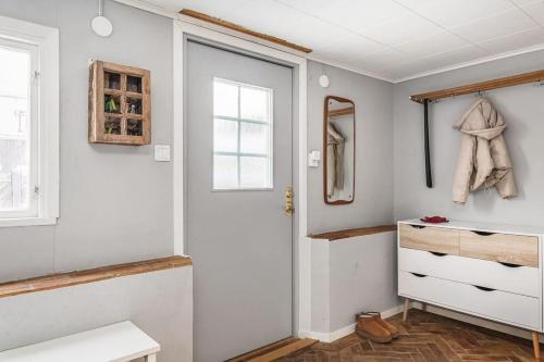 a bathroom with a white door and a mirror at Retro Retreat with Modern Comforts in Stockholm