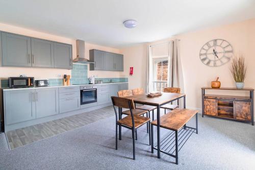 a kitchen with a table and chairs in a room at The Windmill Hotel in Lincolnshire