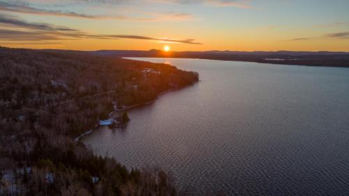 an aerial view of a lake at sunset at Chalet des bouleaux in Nominingue