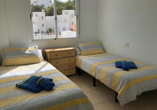 a bedroom with two twin beds and a dresser at Oasis 4 - Mojacar - Sleeps 4 in Mojácar