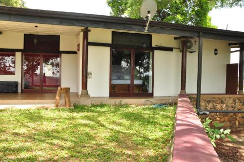 a house with a lawn in front of it at The Buena Vista Kandy in Kandy
