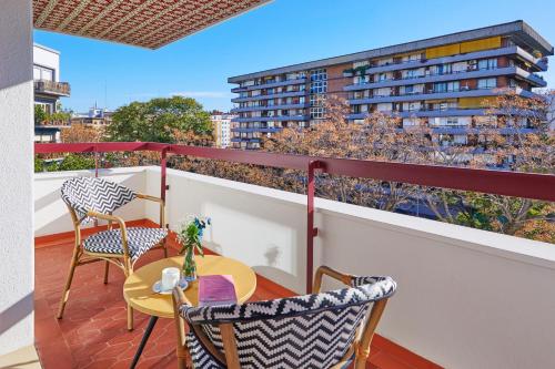 a balcony with a table and chairs and a building at Hesperia Sevilla in Seville