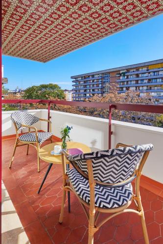 a patio with chairs and a table on a balcony at Hesperia Sevilla in Seville