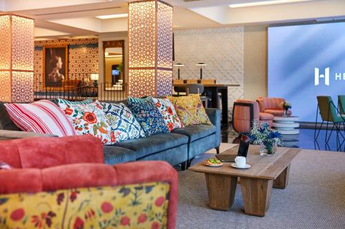 a living room with a couch and a table at Hesperia Sevilla in Seville