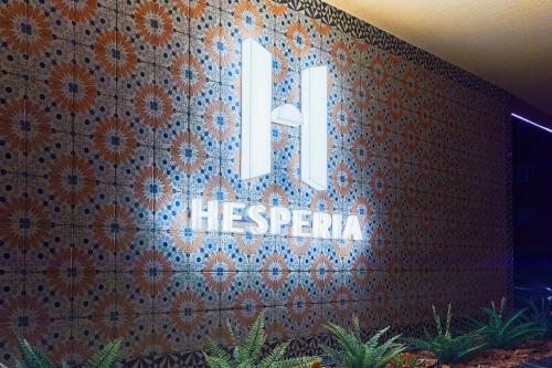 a sign on a wall with the letter m on it at Hesperia Sevilla in Seville