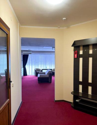 a view of a living room with a couch and a television at Mark Plaza Hotel in Mykolaiv