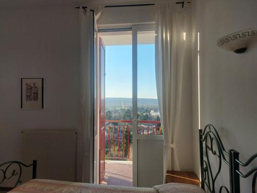 a bedroom with a bed and a window with a view at Il Portichetto in Rivergaro