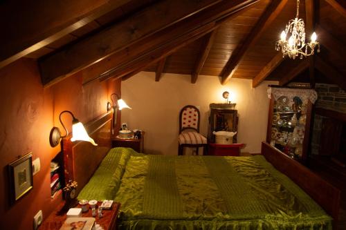 Un dormitorio con una cama verde y una lámpara de araña. en Lila Traditional House, en Kipoi