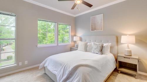a white bedroom with a bed and two windows at Landing Modern Apartment with Amazing Amenities (ID4600X56) in Irving