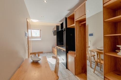 a living room with a table and a dining room at Zama Suites in Zakynthos Town