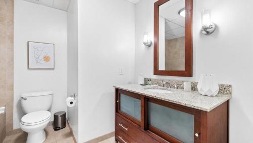 a bathroom with a toilet and a sink and a mirror at Landing Modern Apartment with Amazing Amenities (ID7864X05) in Memphis