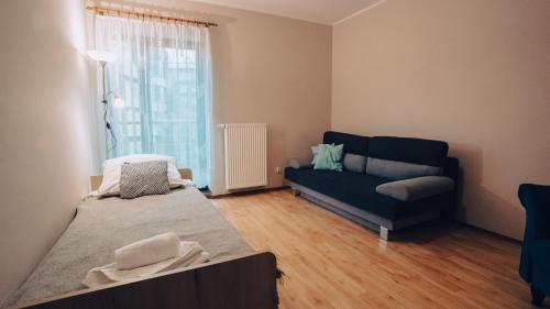 a living room with a couch and a window at Apartament Stylowy - Zeta Park in Ustroń