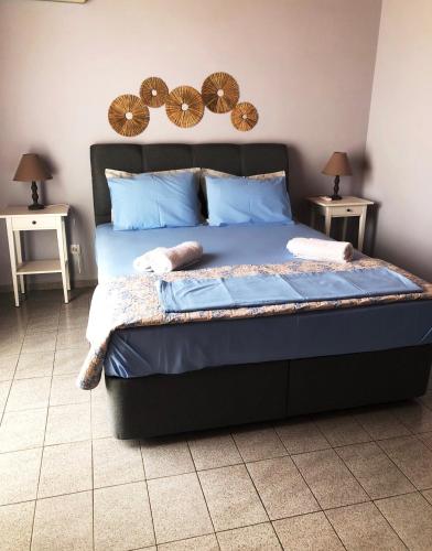 a bedroom with a bed with two night stands at Barbara΄s Apartments in Argostoli