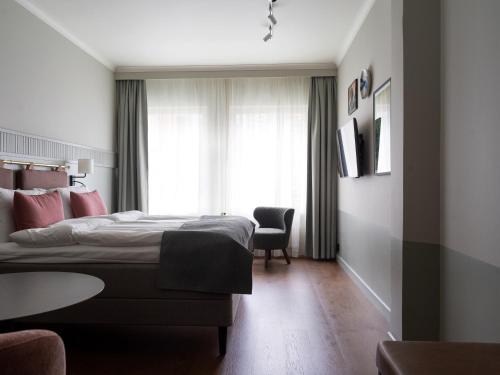 a hotel room with a bed and a window at Elite Palace Hotel & Spa in Stockholm