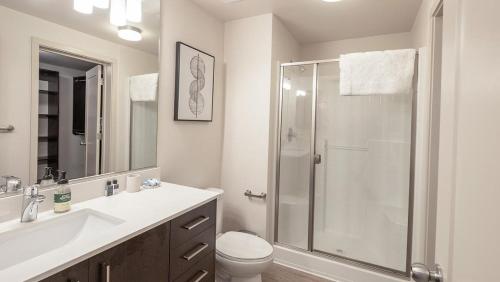 a bathroom with a shower and a toilet and a sink at Landing Modern Apartment with Amazing Amenities (ID6842X82) in West Sacramento