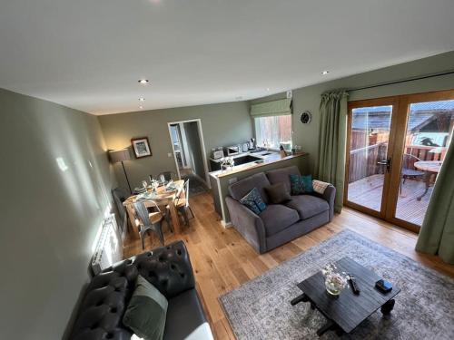 a living room with a couch and a table at The Poplars - Cosy Modern Flat with Great Networking in Telford