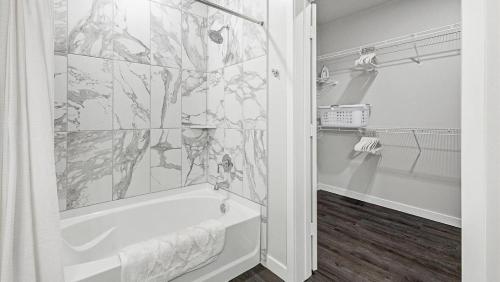 a bathroom with a shower and a bath tub at Landing - Modern Apartment with Amazing Amenities (ID1403X426) in Houston