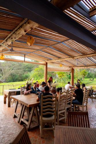 a group of people sitting at a table in a restaurant at El EQUIMITE HOTEL BOUTIQUE in Coatepec