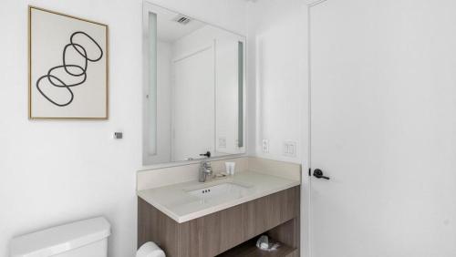 a bathroom with a sink and a mirror at Landing - Modern Apartment with Amazing Amenities (ID1401X725) in Fort Lauderdale