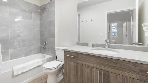 a bathroom with a toilet and a sink and a tub at Landing - Modern Apartment with Amazing Amenities (ID1403X373) in Portland