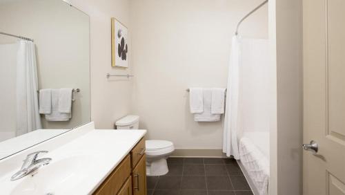 Baño blanco con lavabo y aseo en Landing Modern Apartment with Amazing Amenities (ID2613X64) en Detroit