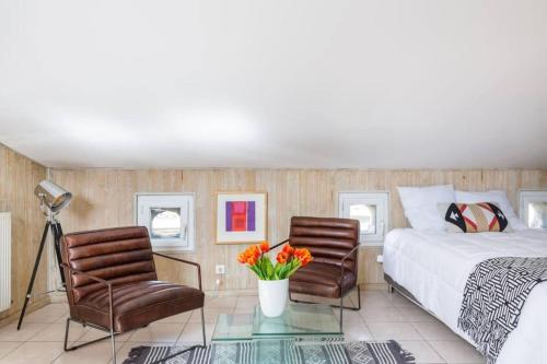 une chambre avec un lit, deux chaises et une table dans l'établissement Spacieux studio Bordeaux centre, à Bordeaux