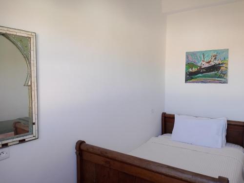 a bedroom with a bed and a mirror on the wall at Riad & Restaurant Ocean Beach Douira in Agadir