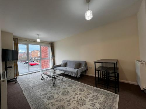 a living room with a couch and a table at Crownford Guesthouse - Close to Hanley centre and University in Stoke on Trent