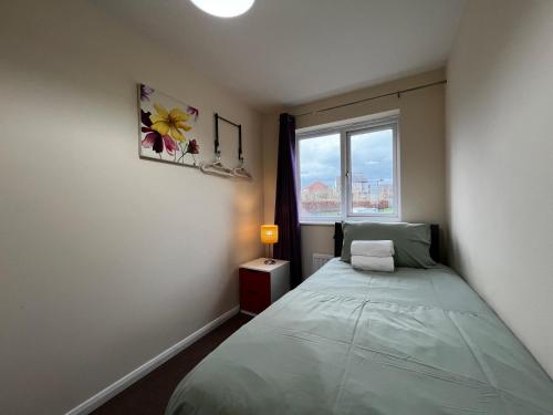 a small bedroom with a bed and a window at Crownford Guesthouse - Close to Hanley centre and University in Stoke on Trent