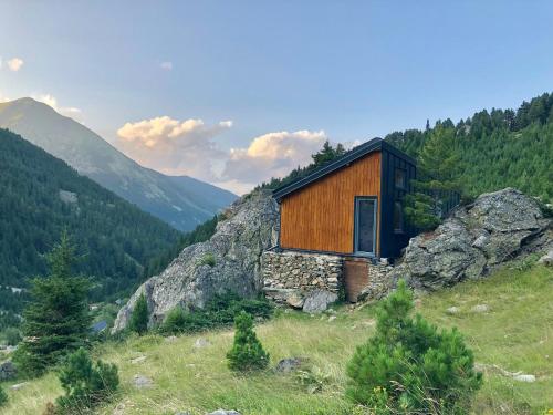a wooden cabin on top of a mountain at Cabin on a Rock - Mountain Escape in Deçan