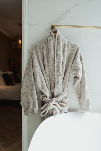 a robe hanging on a wall in a bedroom at Hotel Janssen in Valkenburg