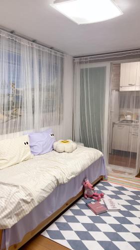 a bedroom with a bed and a checkered floor at Tiny house in Ulsan